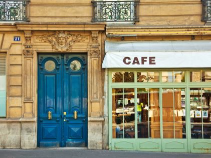 A blue door and awning labeled "Cafe" in Paris