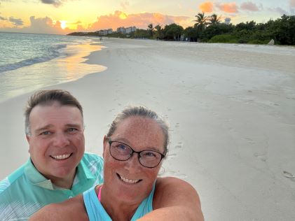 Two Hilton Grand Vacations Members smile on Shoal Beach in Anguilles