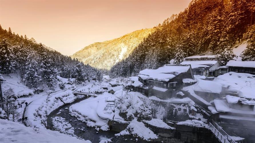 Hot springs and residences tucked in a snowy valley in Yamanouchi, Japan