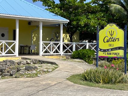 Pastel yellow and blue exterior of Cutters, a restaurant in Barbados near The Crane, a Hilton Grand Vacations Club