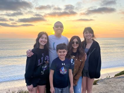 A Hilton Grand Vacations Member and her family at the beach at Carlsbad, California, near MarBrisa, a Hilton Grand Vacations Club
