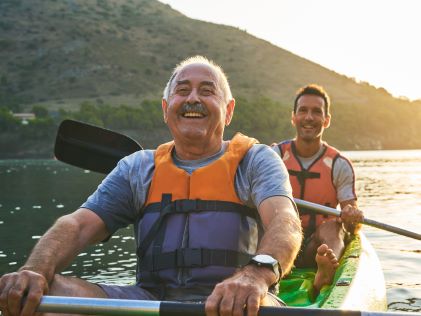 A father and his adult son kayak together