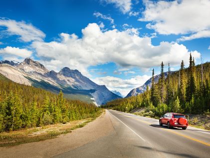 Car on a road through mountains