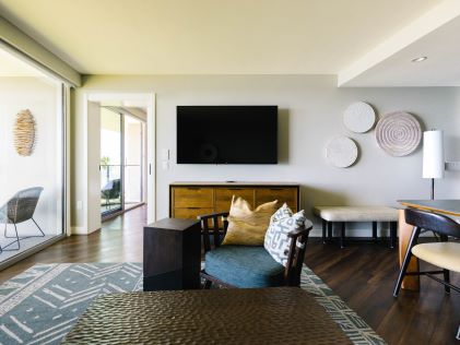 Living room, balcony and kitchen at a 2-Bedroom Suite at Ocean Tower, a Hilton Grand Vacations Club in Hilton Waikoloa Village on the Big Island of Hawaii