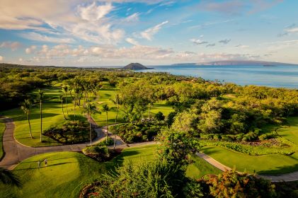 Picturesque aerial image, cliff-side golf course, stunning coastline, blue skies, Wailea, Maui, Hawaii. 