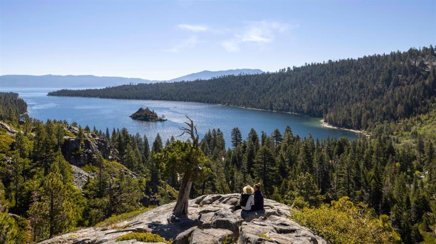 Two hikers overlooking South Lake Tahoe, California