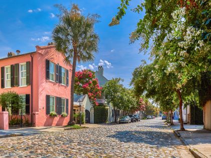 Quaint cobblestone street and colorful homes in Charleston, South Carolina