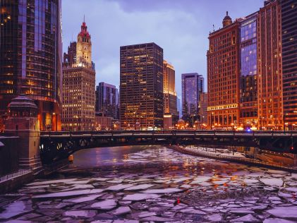 Chicago in the winter and cityscape near a partially frozen river