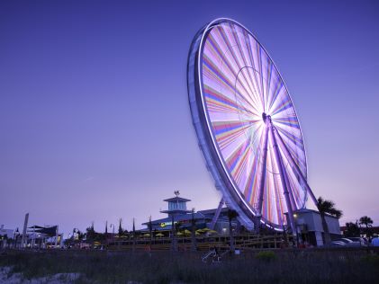 The SkyWheel, a ferris wheel on the boardwalk of Myrtle Beach, South Carolina, at sunset