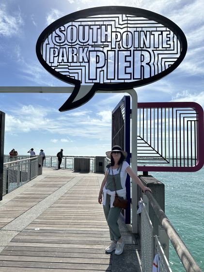 A Hilton Grand Vacations Member posing at South Pointe Park Pier in Miami