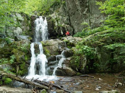 Hiker at waterfalls in Shenandoah National Park in Virginia