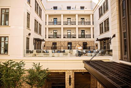 Wide shot image, couple enjoying the roof top patio, Liberty Place Charleston, a Hilton Club, Charleston, South Carolina. 